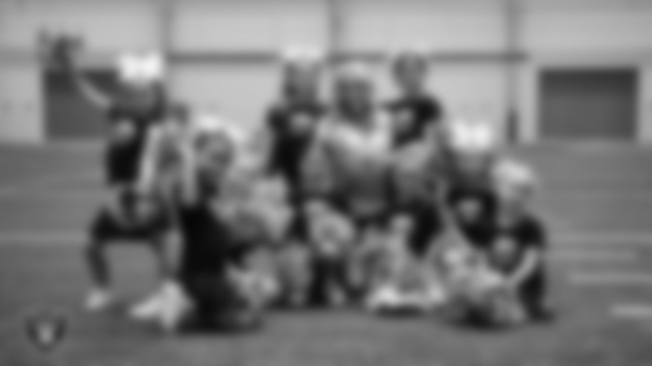 Raiderette Kennedy poses for a photo with dancers during day three of summer camp at Intermountain Health Performance Center.