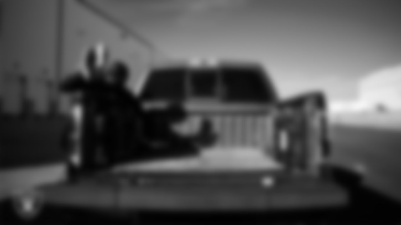 A Las Vegas Raiders ambassador loads equipment into a vehicle during the Raiders' Equipment Blitz at Intermountain Health Performance Center.