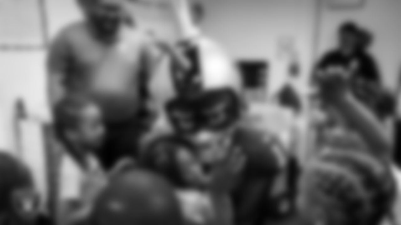 Raider Rusher hugs a student during a 'Lil Raiders Pop-Up at Matt Kelly Elementary School.