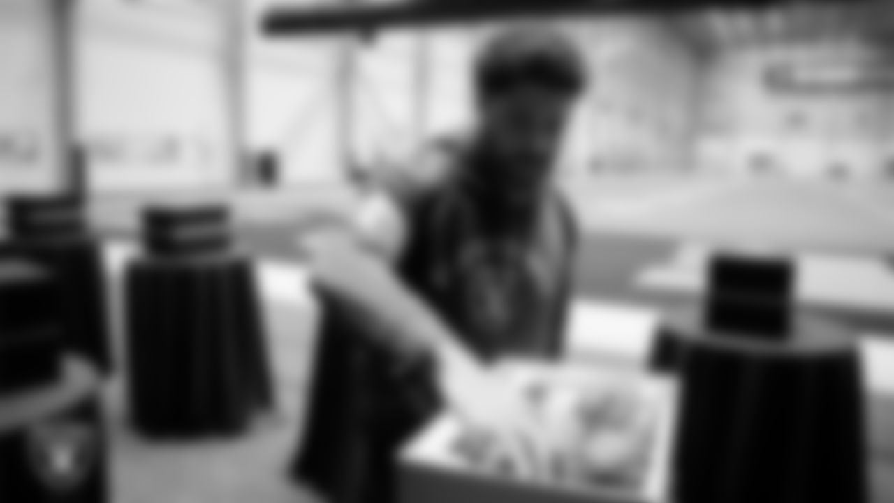 Las Vegas Raiders tight end Albert Okwuegbunam (86) unboxes his custom cleats for the NFL's My Cause My Cleats initiative at Intermountain Health Performance Center.