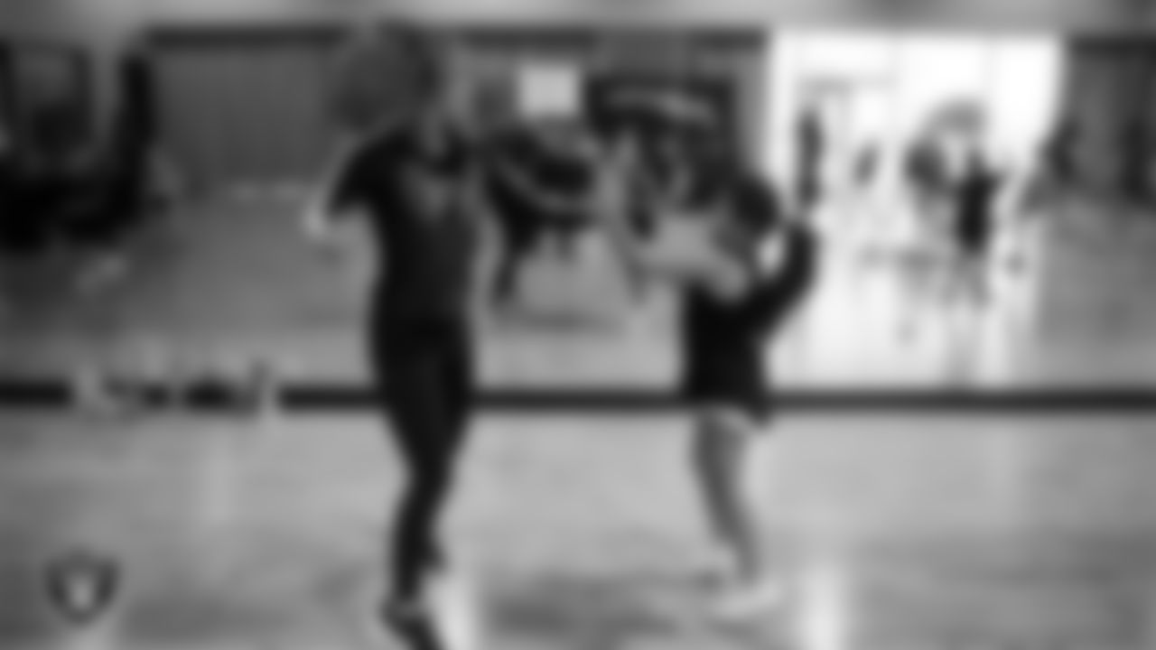 Raiderette Lexie with a dancer during day one of summer camp at The Studio.