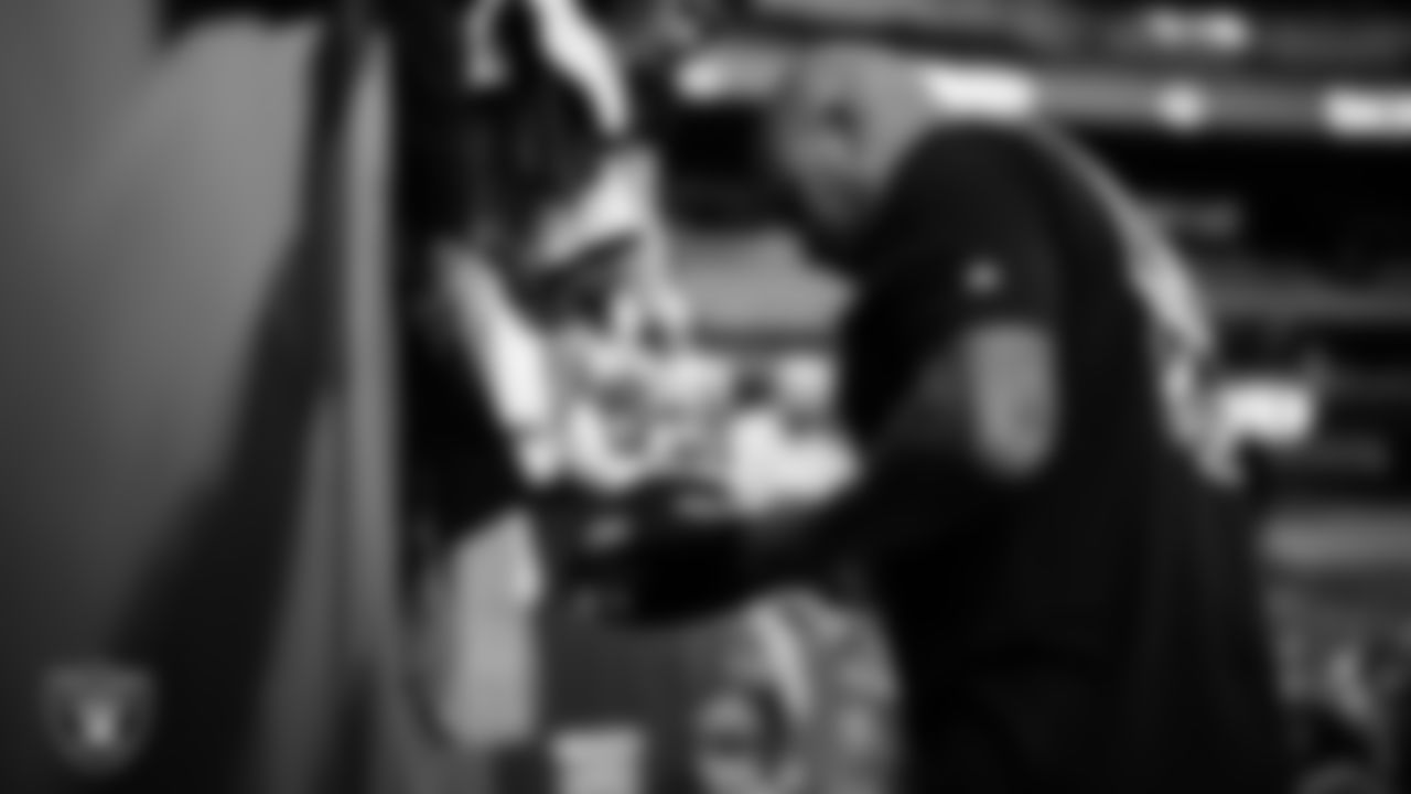 Las Vegas Raiders Head Coach Antonio Pierce signs autographs for fans before the preseason home game against the San Francisco 49ers at Allegiant Stadium.