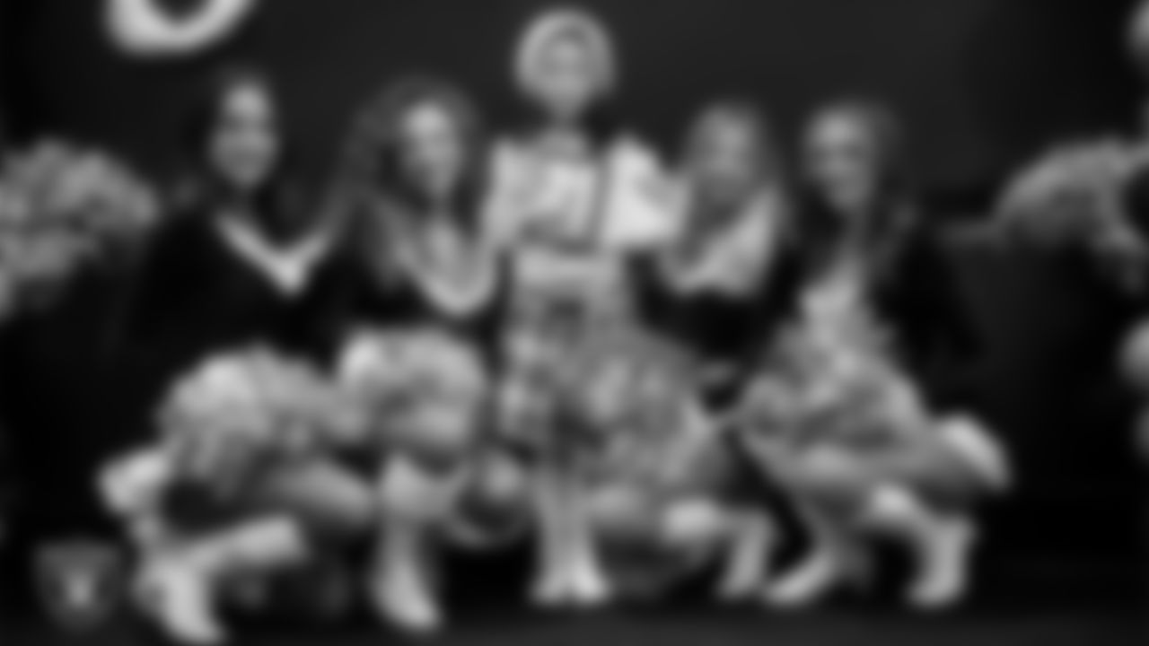 Raiderettes pose for a photo with a Junior Raiderette during the Junior Raiderettes Banquet at The Studio.