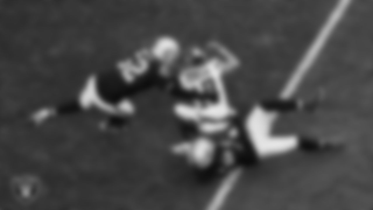 Las Vegas Raiders linebacker Elandon Roberts (52) and safety Lonnie Johnson Jr. (32) make a tackle during the regular season home game against the New York Giants at Allegiant Stadium.
