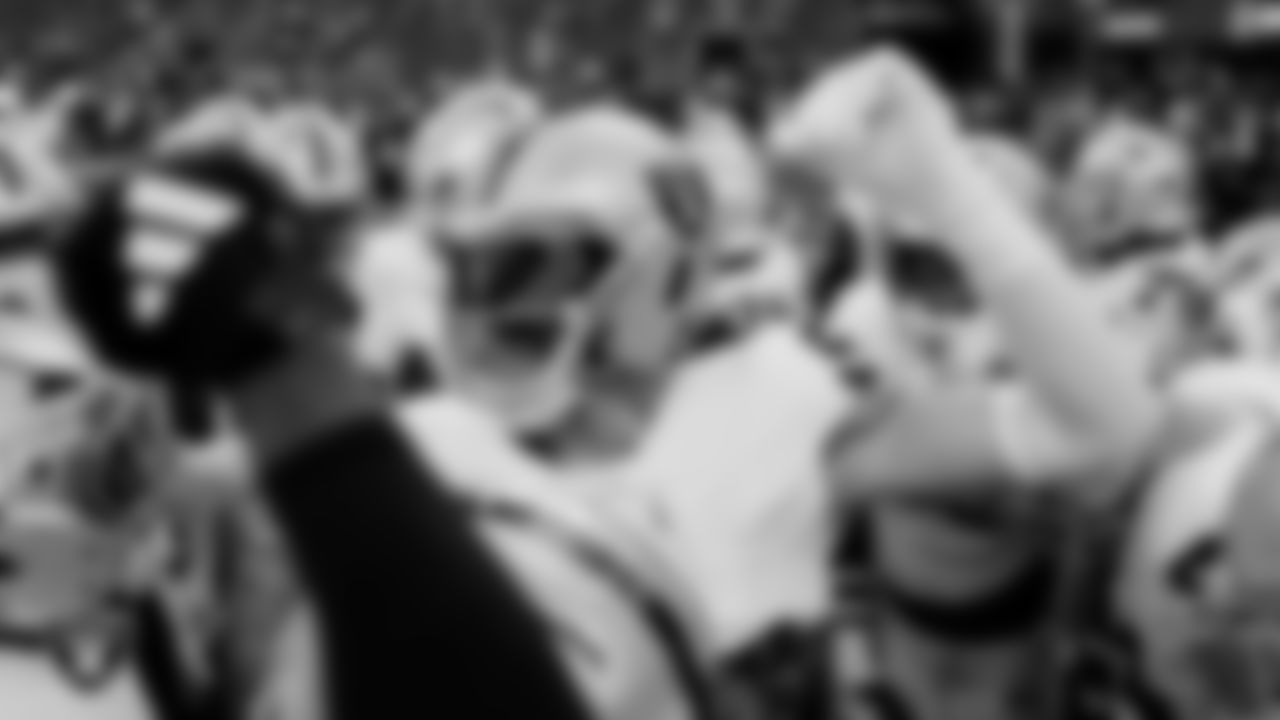 Las Vegas Raiders defensive end Maxx Crosby (98) leads a huddle during warm ups before the preseason away game against the Seattle Seahawks at Lumen Field.
