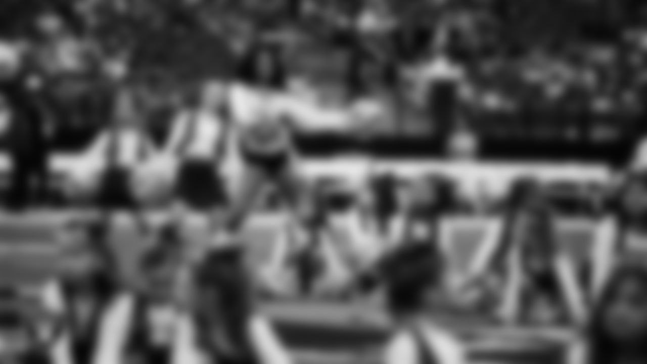 Raiderette Shayla and Junior Raiderettes perform on the field before the preseason home game against the San Francisco 49ers at Allegiant Stadium.