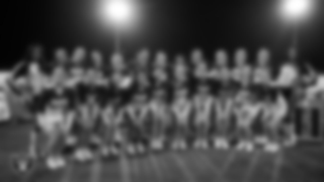 Raiderettes Maddie and Cierra pose for a photo with the Moapa Valley High School cheer team before the Las Vegas Raiders' Football Showcase game at Moapa Valley High School.