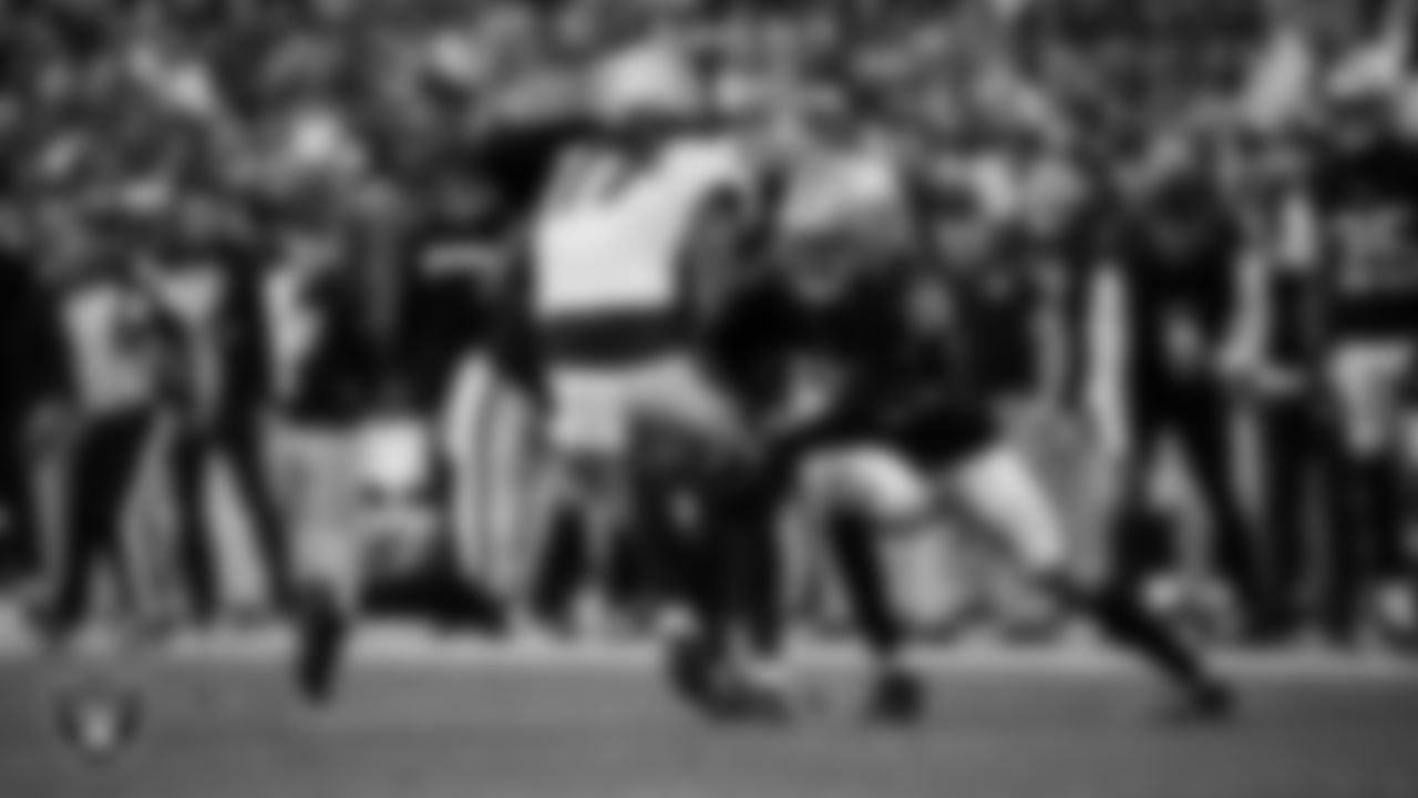 Las Vegas Raiders linebacker Elandon Roberts (52) and cornerback Eric Stokes (22) make a tackle during the regular season home game against the Denver Broncos at Allegiant Stadium.