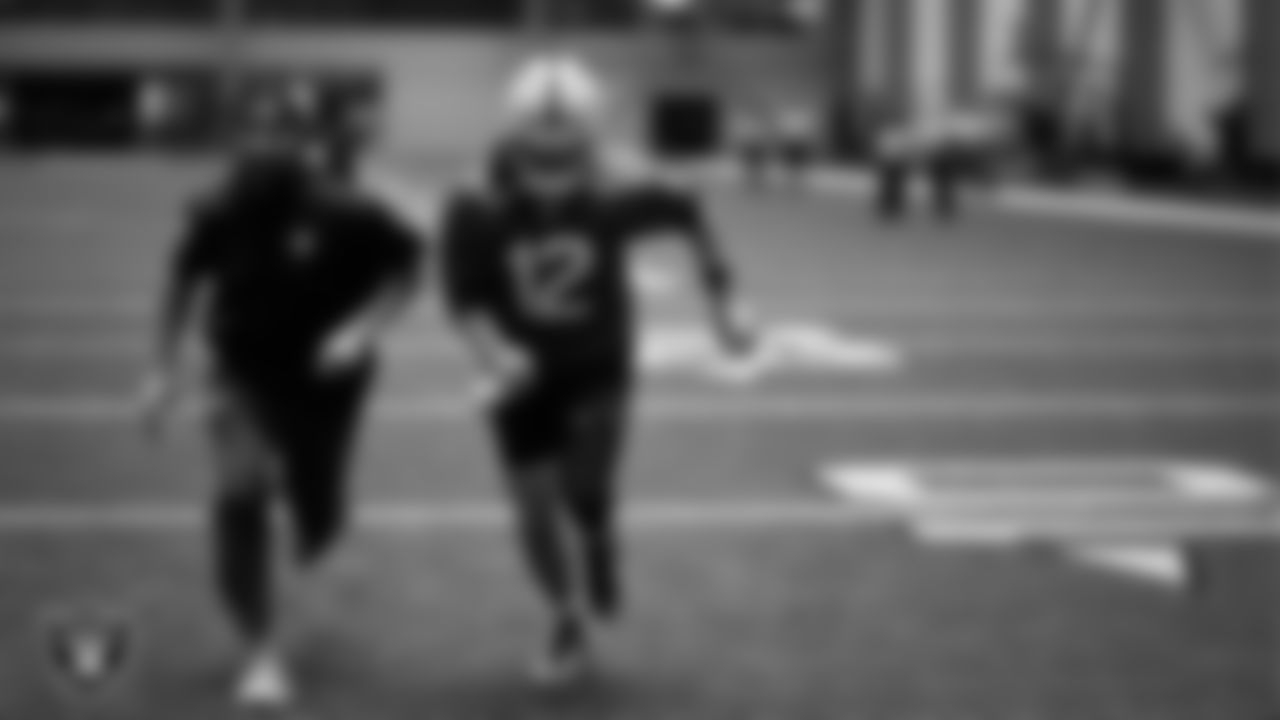 Las Vegas Raiders run game coordinator/defensive line coach Rob Leonard and quarterback Aidan O'Connell (12) during practice at Intermountain Health Performance Center.