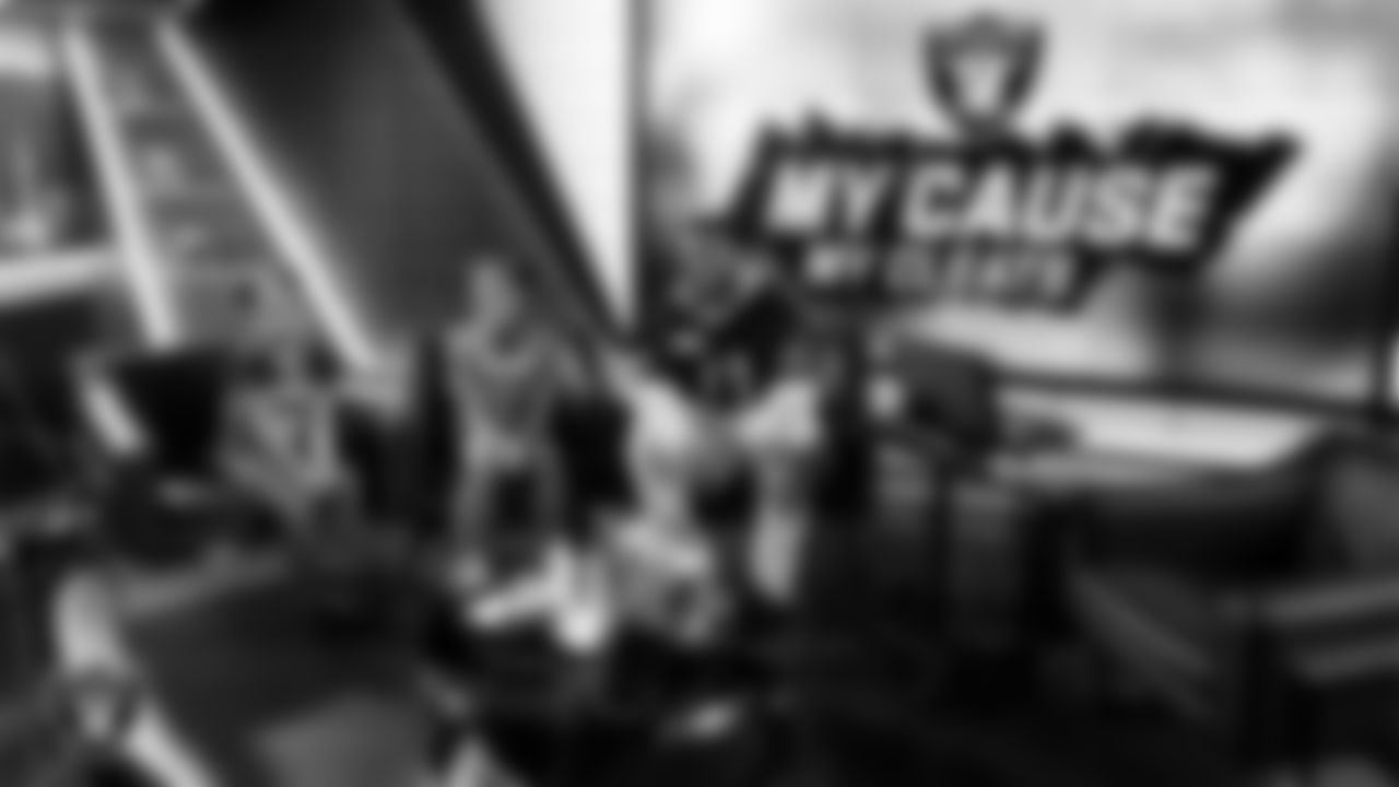 Las Vegas Raiders safety Jeremy Chinn (11) poses for a photo with athletes from the Raiders Silver & Black League after designing cleats for My Cause My Cleats in Cox Studios at Intermountain Health Performance Center.