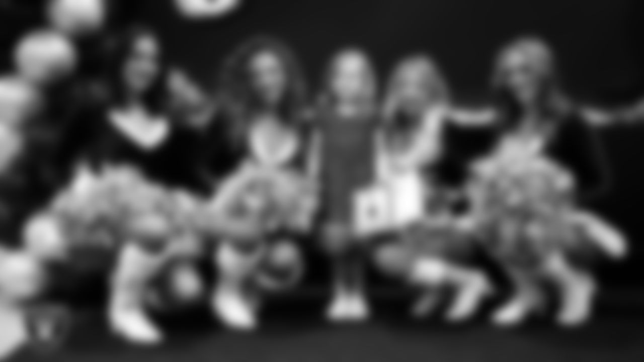 Raiderettes pose for a photo with a Junior Raiderette during the Junior Raiderettes Banquet at The Studio.