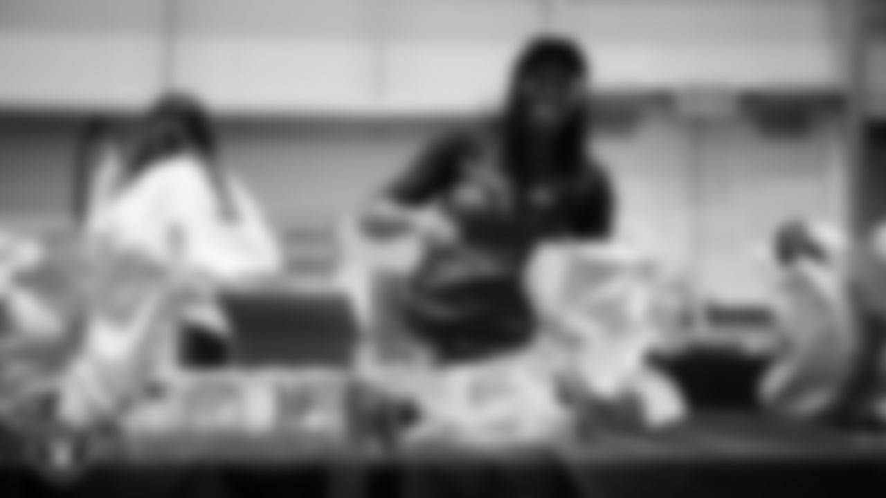 Las Vegas Raiders staff members help pack meals during the Raiders Holiday Meal Packing Party at Intermountain Health Performance Center.