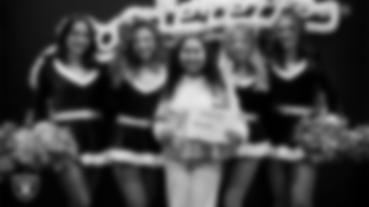 Raiderettes pose for a photo with a Junior Raiderette during the Junior Raiderettes Banquet at The Studio.