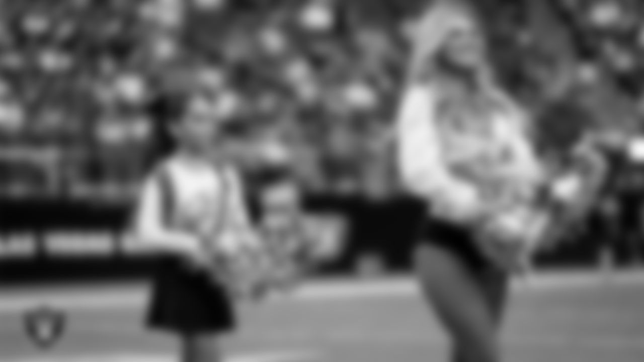 Raiderette Ali and Junior Raiderettes perform on the field before the preseason home game against the San Francisco 49ers at Allegiant Stadium.
