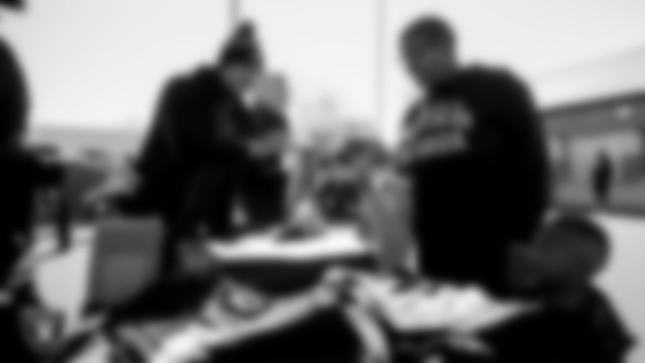 Attendees receive Las Vegas Raiders gear during Silver and Black Saturday at Liberty High School.