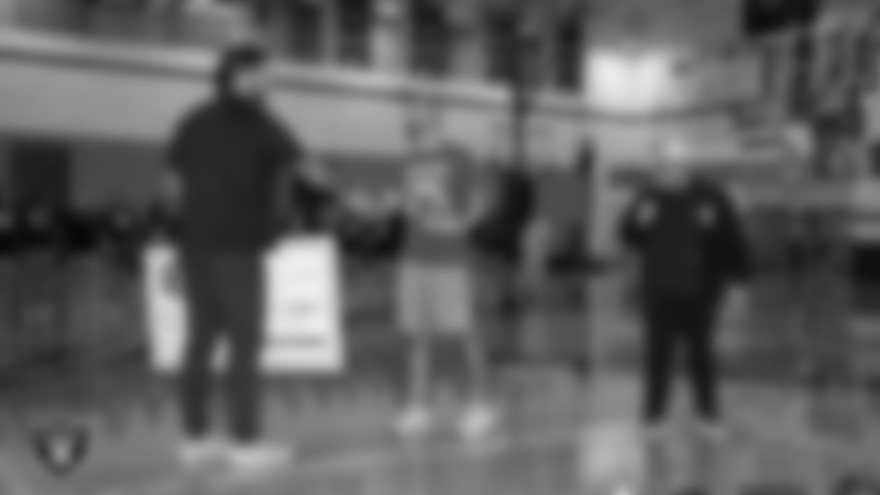 Las Vegas Raiders alumnus Robert Gallery and senior manager of football development Jordan Aguilar present Spanish Springs High School football coach Rob Hummel with the Tom Flores Coach of the Year award at Spanish Springs High School.