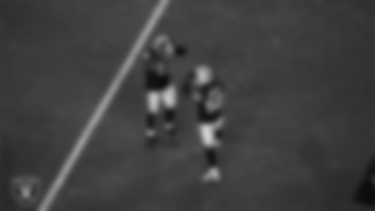 Las Vegas Raiders linebacker Devin White (45) and linebacker Elandon Roberts (52) celebrate after making a tackle during the regular season home game against the Los Angeles Chargers at Allegiant Stadium.