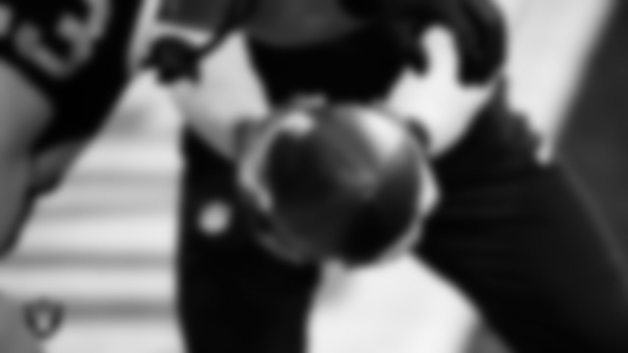 A Las Vegas Raider and coach warming up before the regular season home game against the Denver Broncos at Allegiant Stadium.