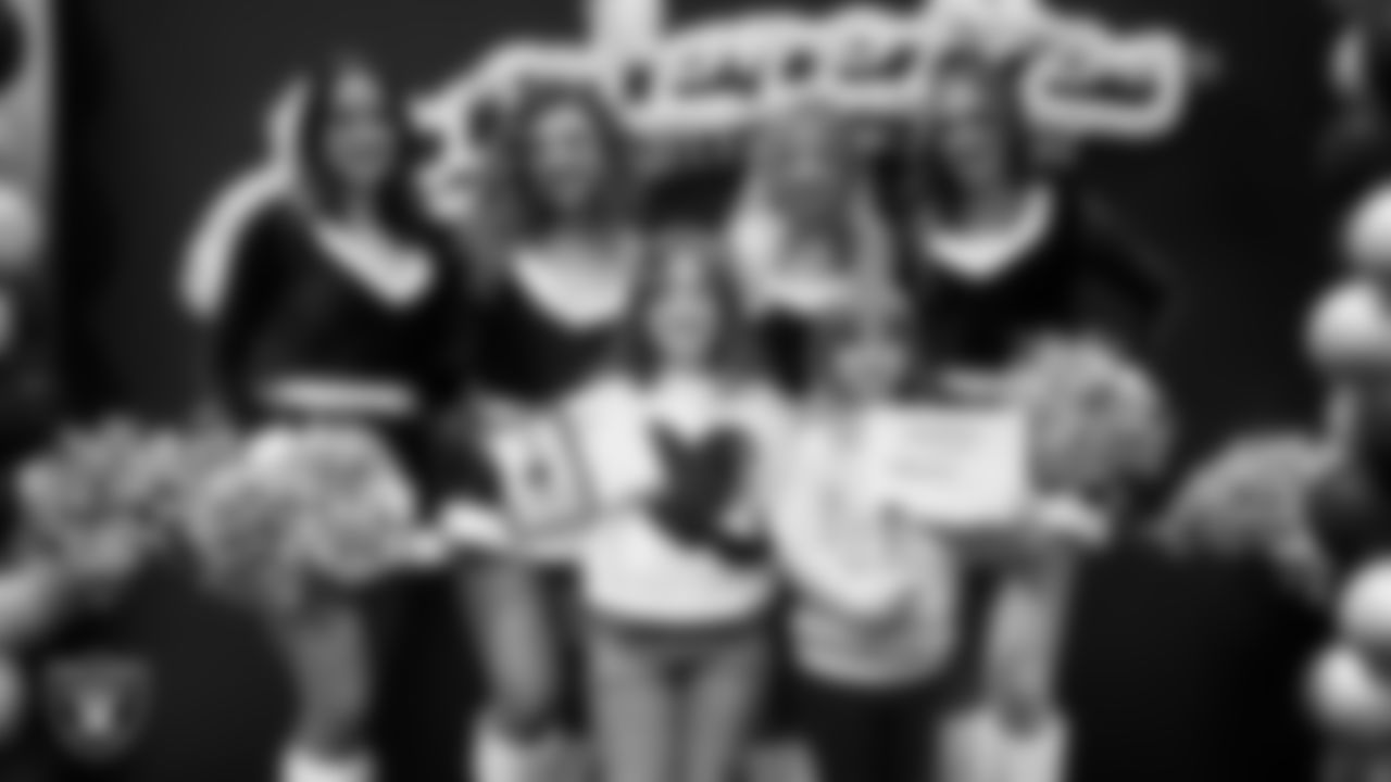 Raiderettes pose for a photo with Junior Raiderettes during the Junior Raiderettes Banquet at The Studio.