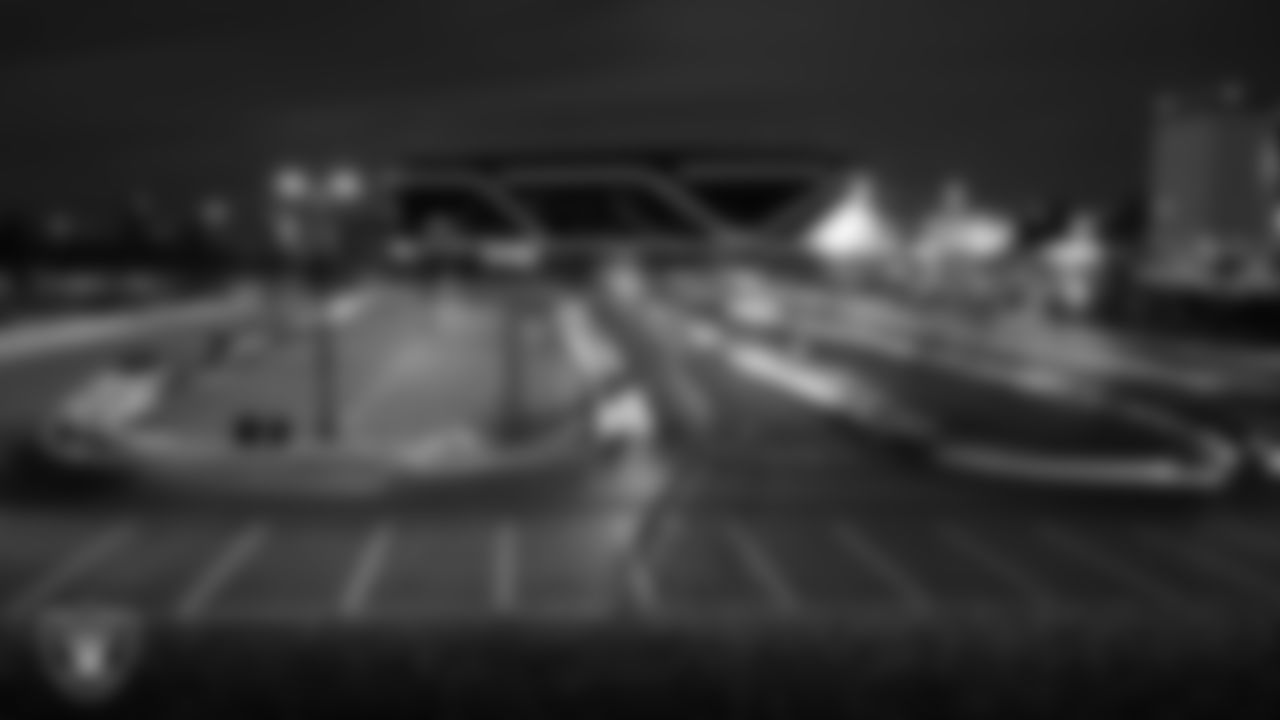 Cars make their way through the parking lot to receive a Thanksgiving meal during Turkey Time with the O-Line at Allegiant Stadium.