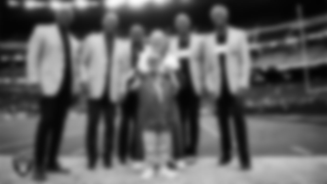 Las Vegas Raiders Owner Mark Davis poses for a photo with alumni Eric Dickerson, Marcus Allen, Tim Brown, James Lofton and Mike Haynes and Intermountain Children's Health patient Benji before the regular season home game against the Tennessee Titans at Allegiant Stadium.
