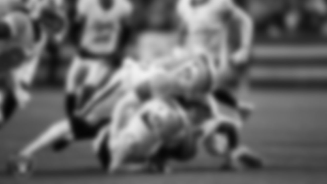 Las Vegas Raiders linebacker Tommy Eichenberg (44) and cornerback Decamerion Richardson (25) make a tackle during the regular season away game against the Denver Broncos at Empower Field at Mile High.