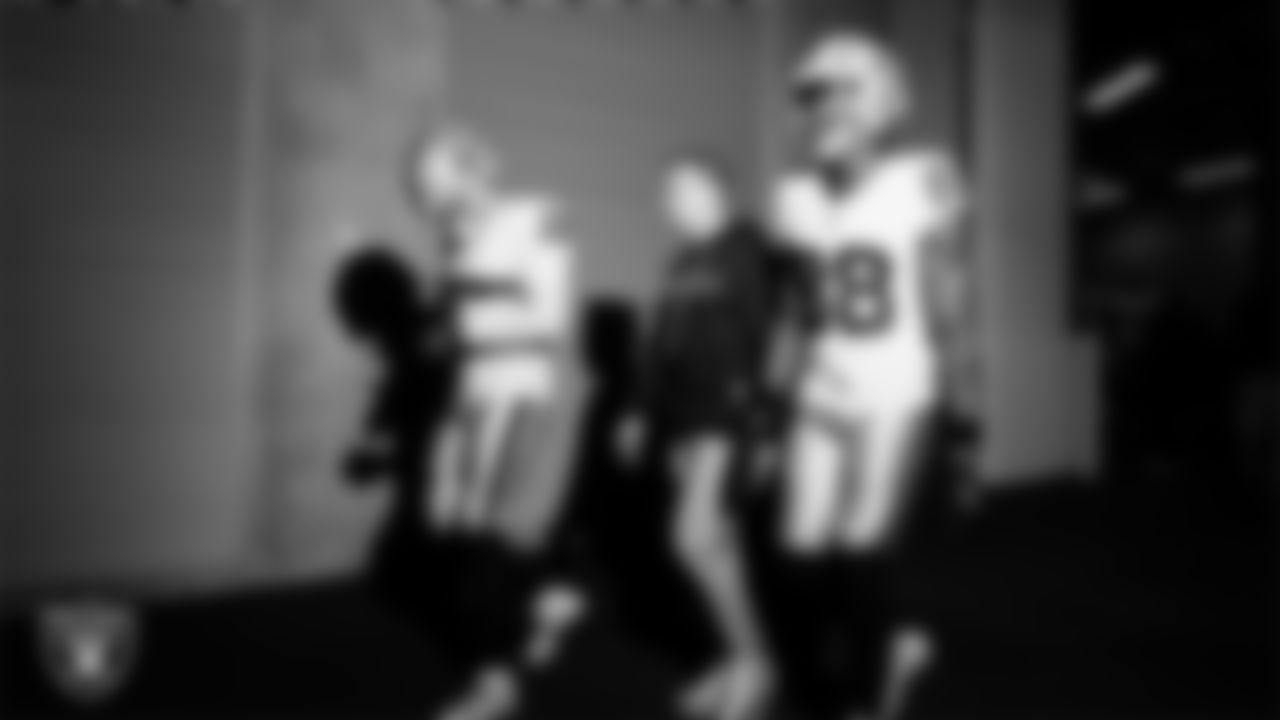 Las Vegas Raiders wide receiver Jack Bech (18), offensive quality control coach Conner McQueen and wide receiver Justin Shorter (88) walk down the tunnel before the regular season away game against the Indianapolis Colts at Lucas Oil Stadium.