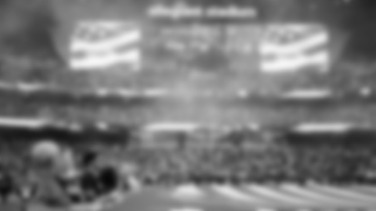 The American flag is displayed by Personal Seat License (PSL) holders on the field during the national anthem before the Las Vegas Raiders' preseason home game against the San Francisco 49ers at Allegiant Stadium.
