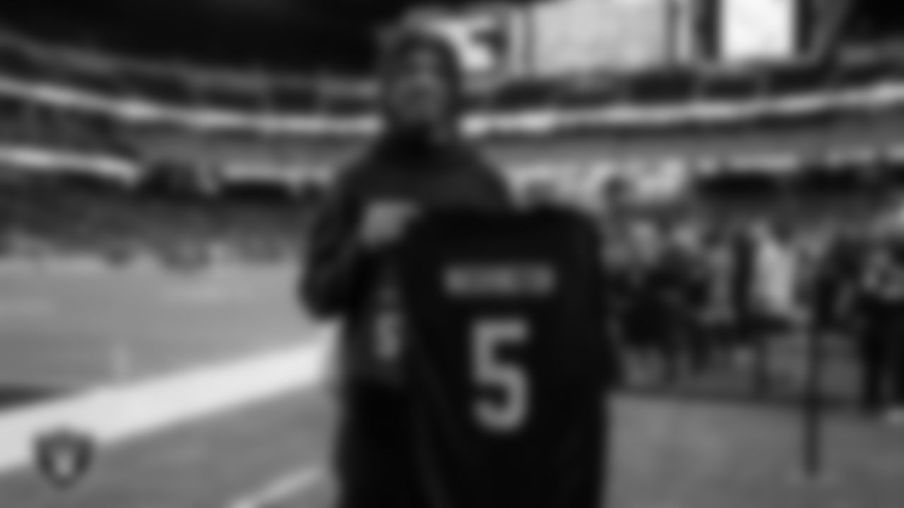 Bishop Gorman High School football player Jett Washington poses for a photo with a custom jersey after receiving an invitation to the Nike Next Ones event for Super Bowl LIX before the Las Vegas Raiders' regular season home game against the Jacksonville Jaguars at Allegiant Stadium.