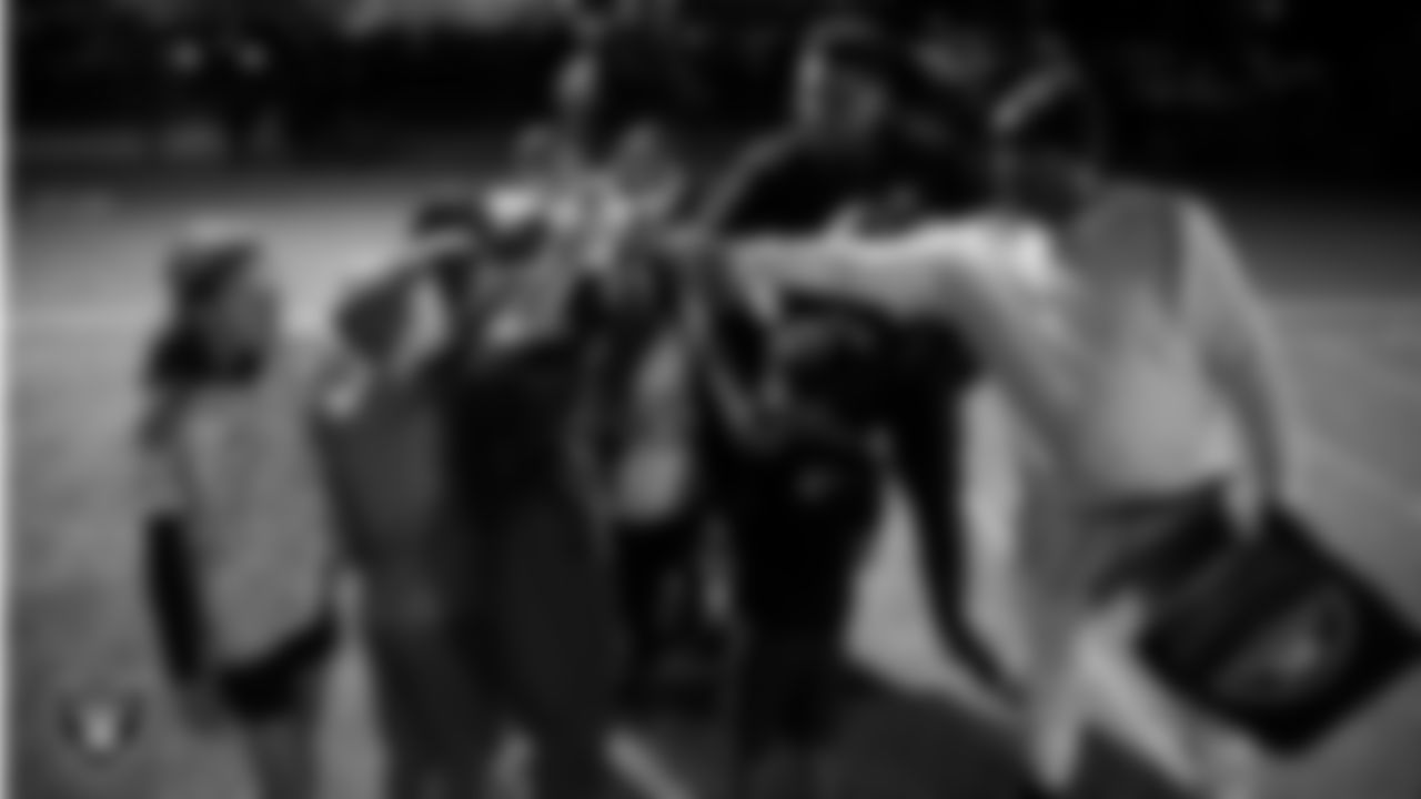 Athletes take part in a Silver and Black League flag football clinic at Bill and Lillie Heinrich YMCA.