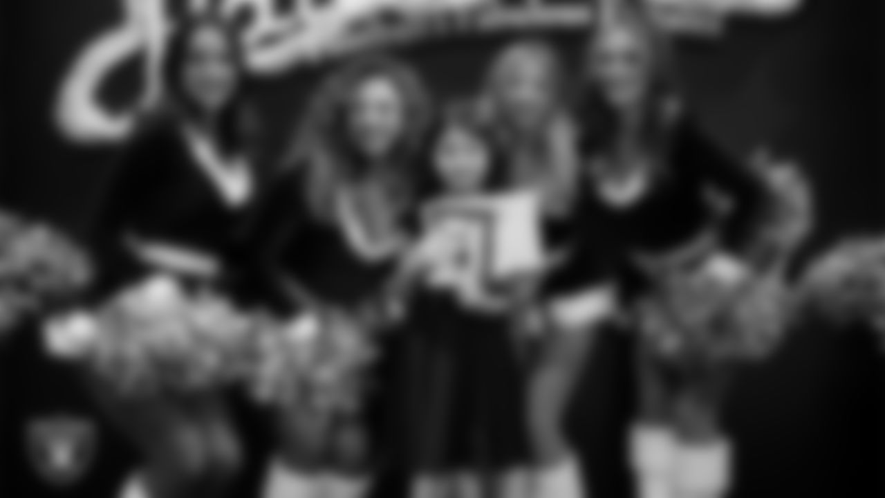 Raiderettes pose for a photo with a Junior Raiderette during the Junior Raiderettes Banquet at The Studio.