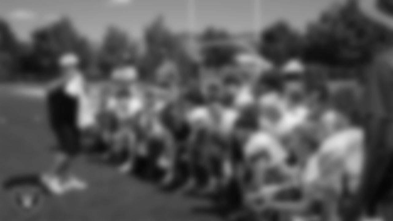 Las Vegas Raiders senior manager of football development Jordan Aguilar hands out High School Football Showcase t-shirts to the Bishop Manogue High School football team during practice at Bishop Manogue High School.