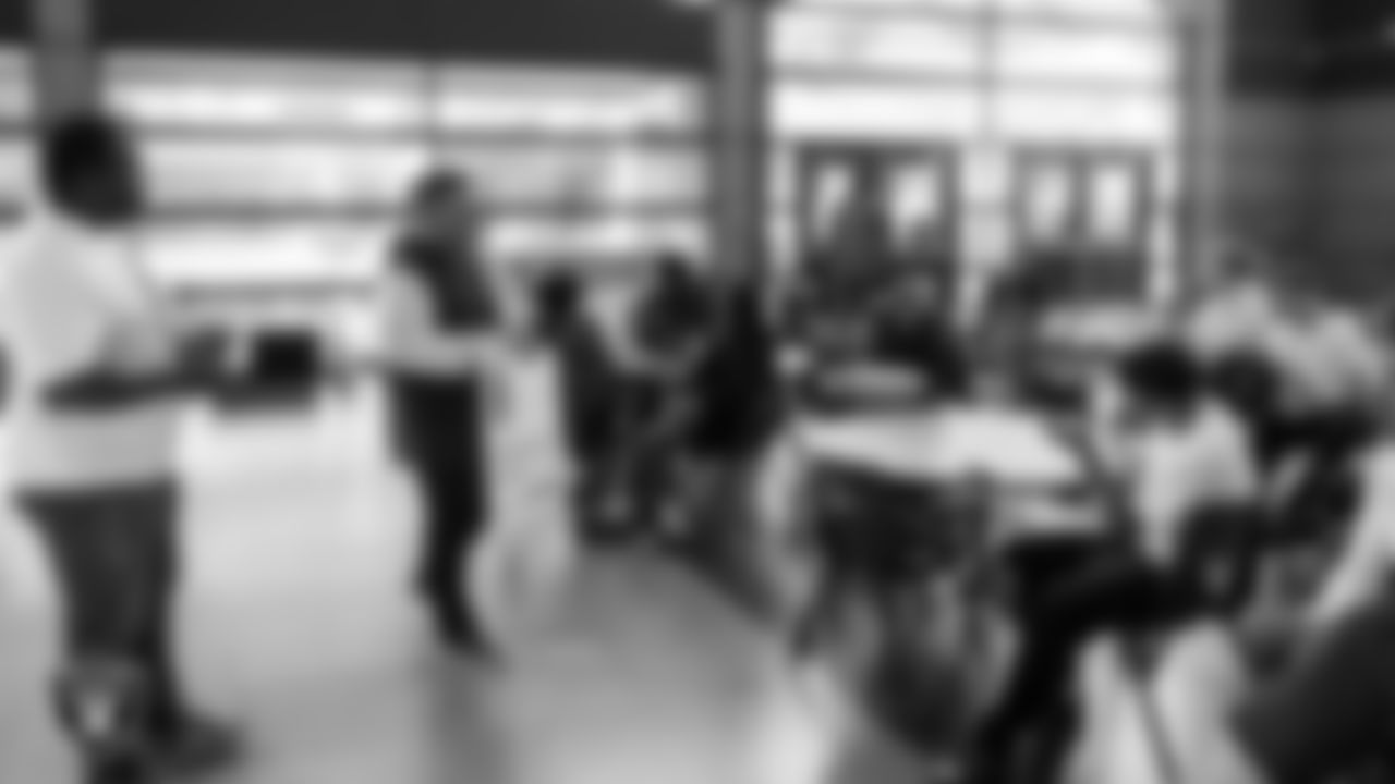 Las Vegas Raiders senior manager of football development Jordan Aguilar presents Spring Valley High School football coach Eric Dyer with the Tom Flores Coach of the Week award after practice at Spring Valley High School.