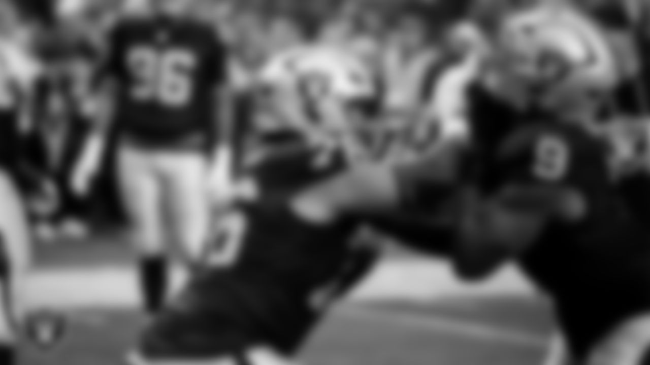 Las Vegas Raiders guard Caleb Rogers (76) and defensive end Tyree Wilson (9) warming up before the regular season home game against the Denver Broncos at Allegiant Stadium.