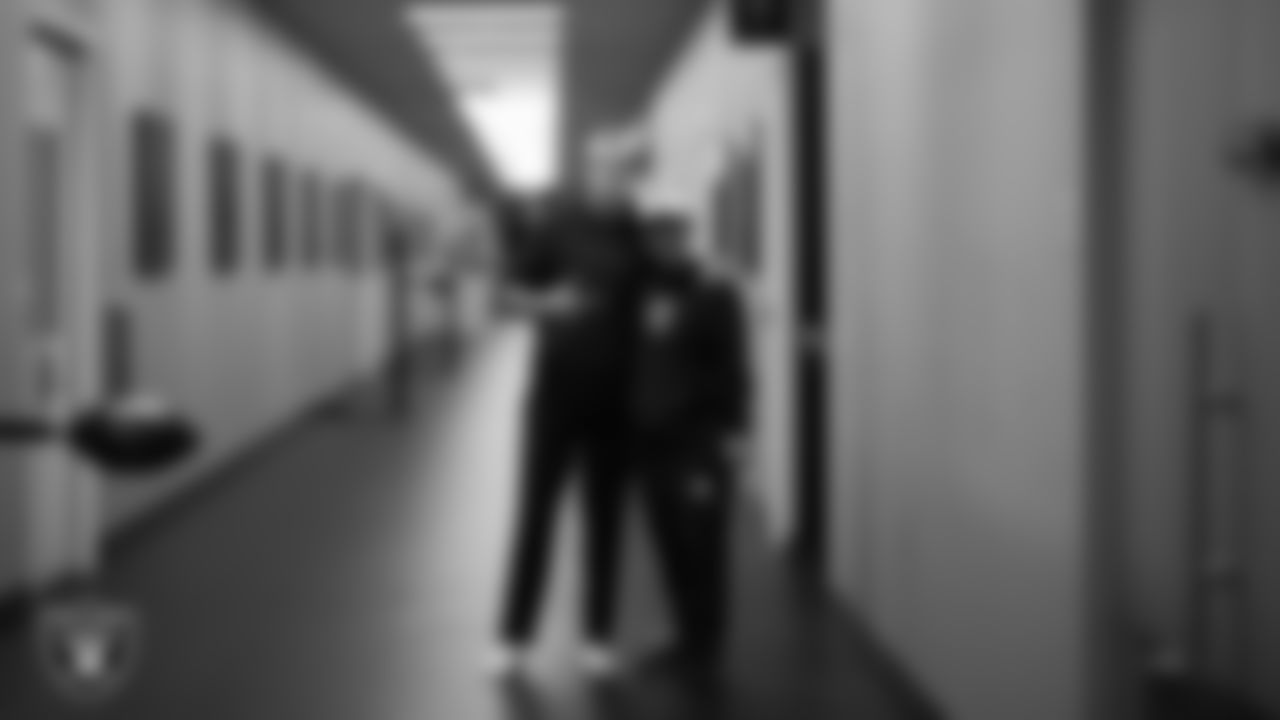 Las Vegas Raiders quarterback Aidan O'Connell (12) and assistant special teams coach Kade Rannings during practice at Intermountain Health Performance Center.