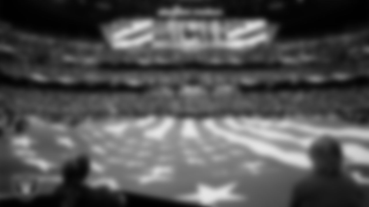 The American flag is displayed by Personal Seat License (PSL) holders on the field during the national anthem before the Las Vegas Raiders' regular season home game against the New York Giants at Allegiant Stadium.