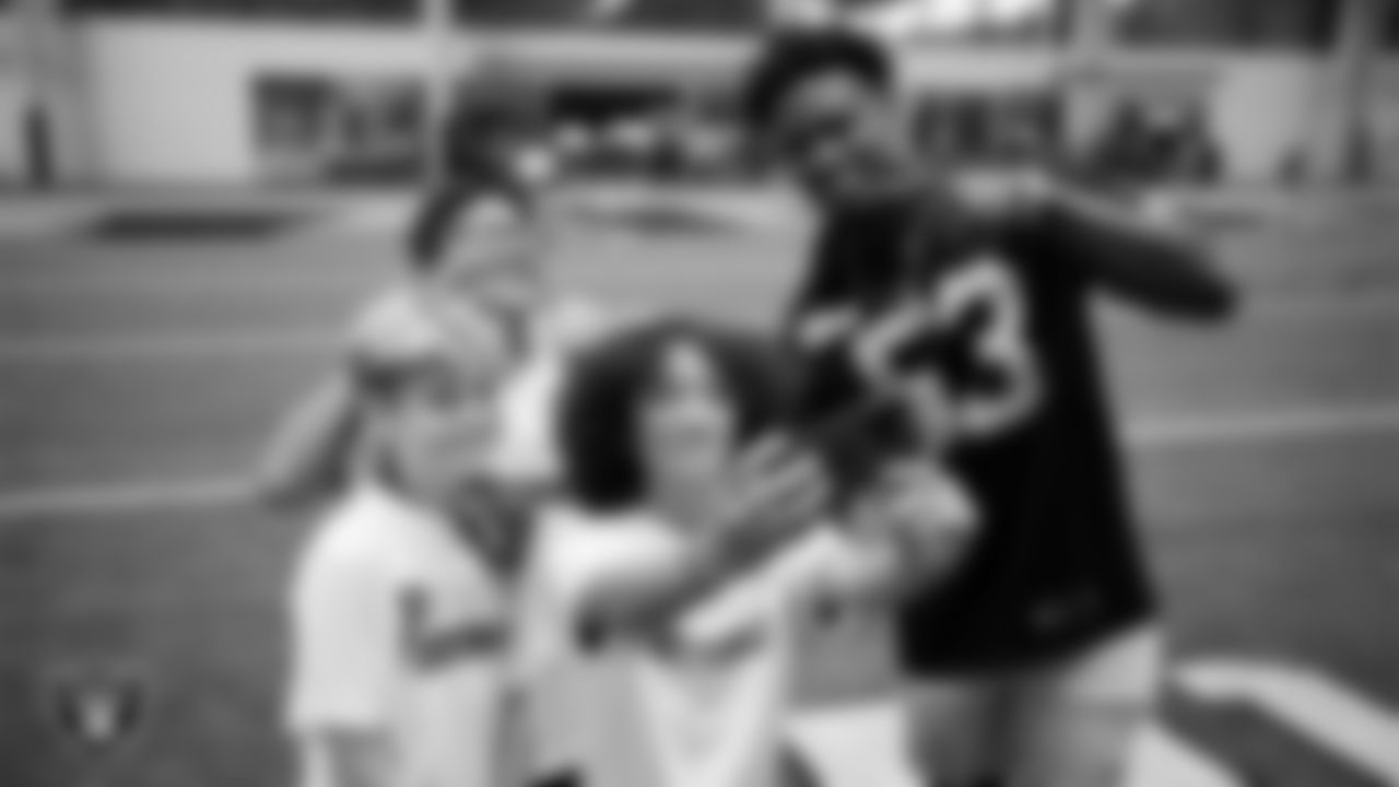 Las Vegas Raiders linebacker Amari Gainer (53) poses for a selfie with athletes at a skills camp during Play Football Day at Intermountain Health Performance Center.