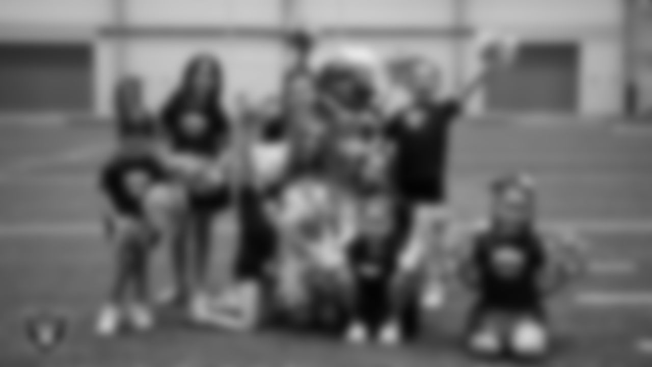 Raiderette Lexie poses for a photo with dancers during day three of summer camp at Intermountain Health Performance Center.