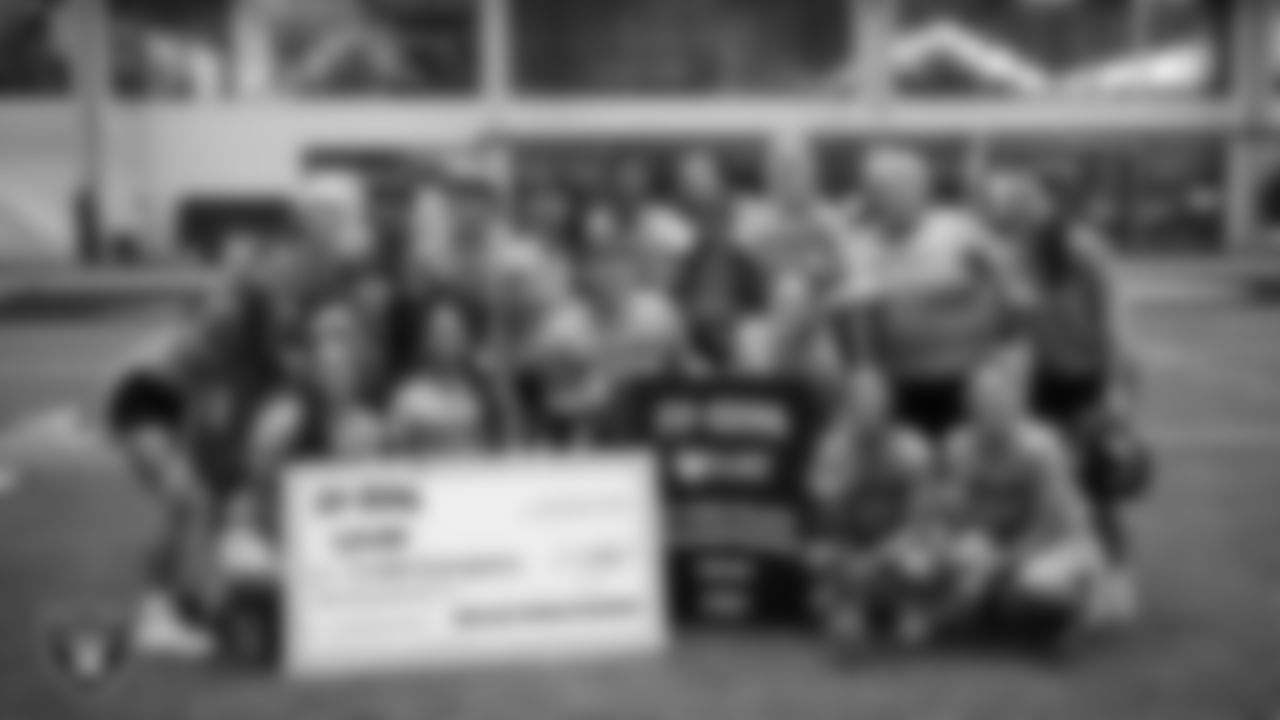 A girls flag football team poses for a photo after winning the Nike 11-On Flag Football Championship at Intermountain Health Performance Center.