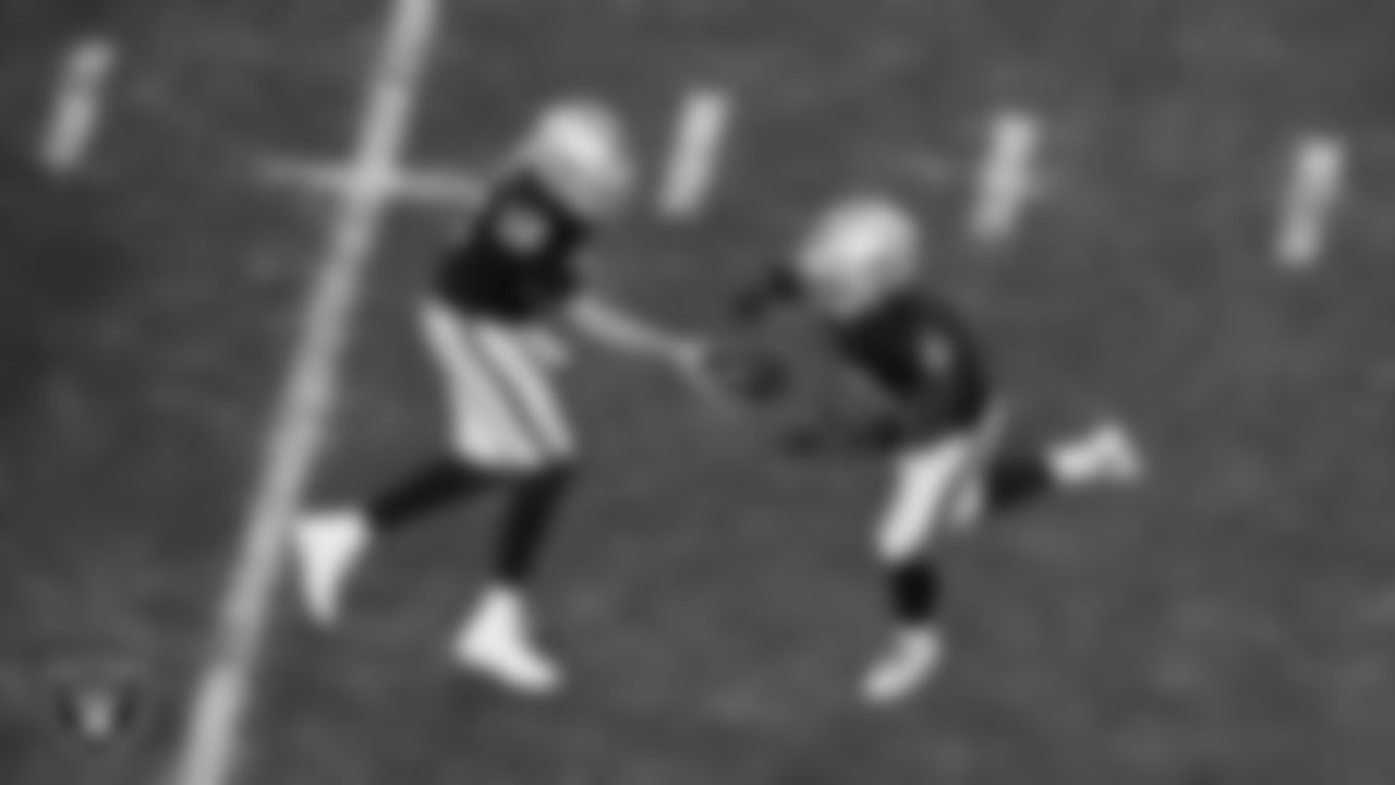 Las Vegas Raiders quarterback Aidan O'Connell (12) hands the ball off to running back Ashton Jeanty (2) during the regular season home game against the Kansas City Chiefs at Allegiant Stadium.