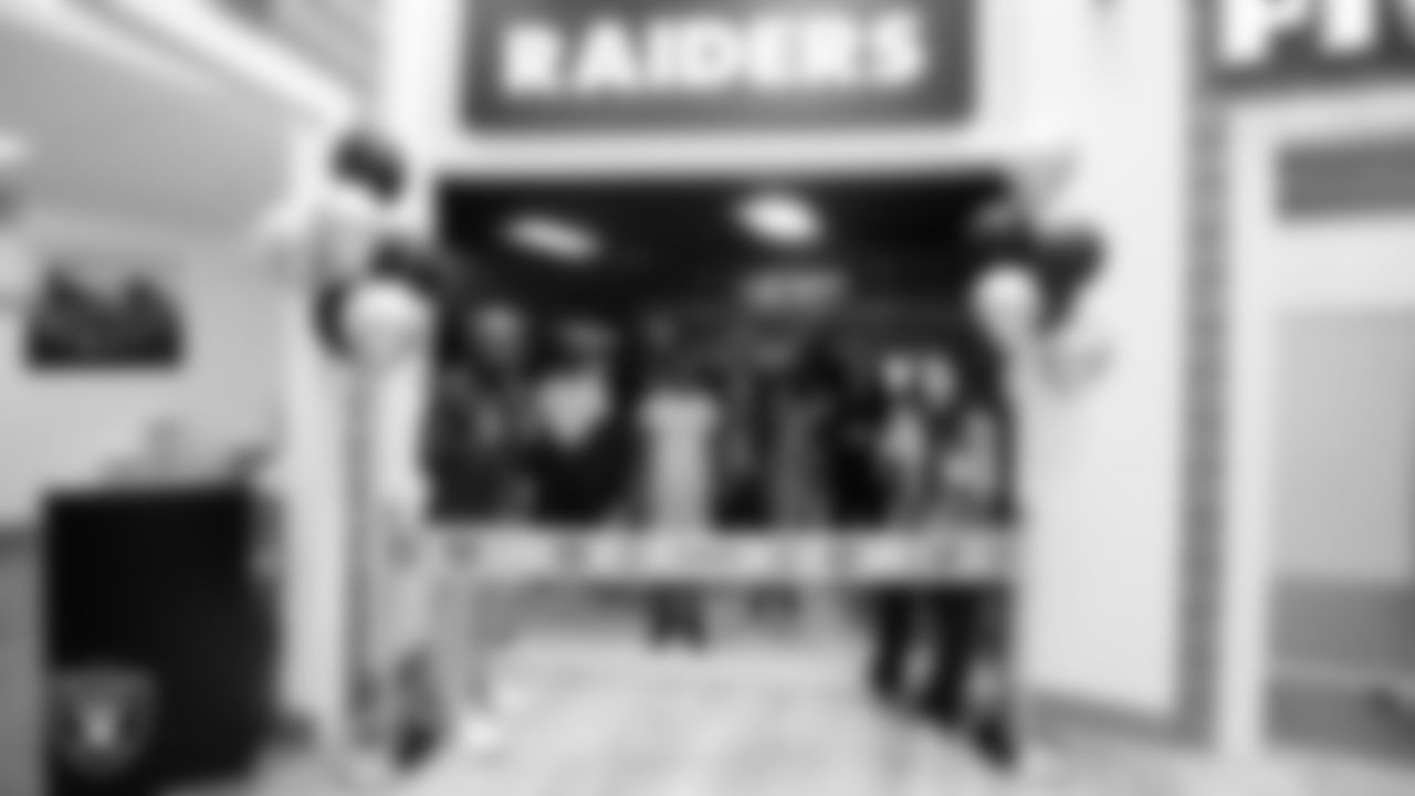 Las Vegas Raiders senior vice president and chief financial officer Michael Crome and executive director of the Raiders Foundation Kari Uyehara during a ribbon cutting at Betty's Junior Achievement BizTown.