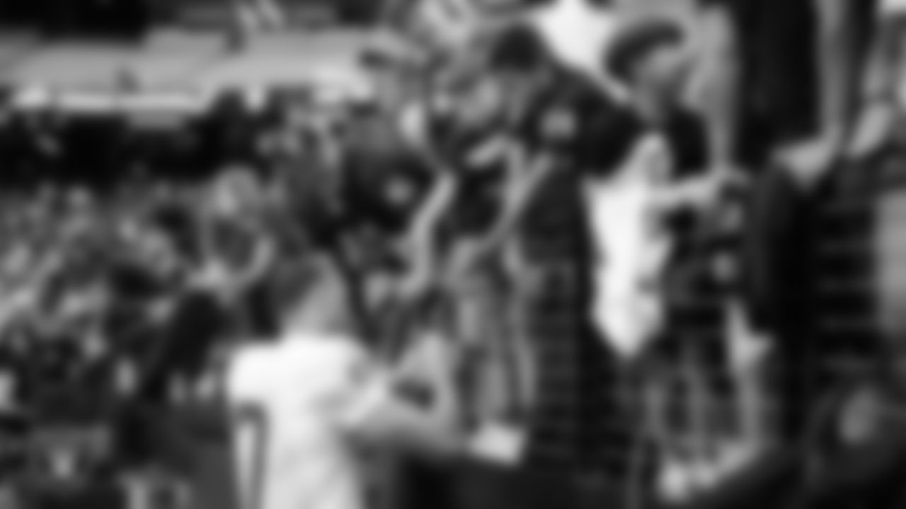 Las Vegas Raiders wide receiver Collin Johnson (17) signs autographs for fans after a 2025 Training Camp mock game at Allegiant Stadium.