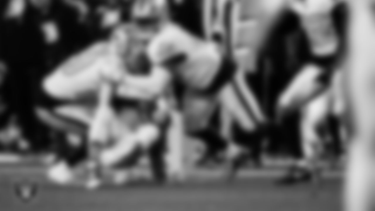 Las Vegas Raiders safety Isaiah Pola-Mao (20) and linebacker Devin White (45) makes a tackle during the regular season away game against the Denver Broncos at Empower Field at Mile High.