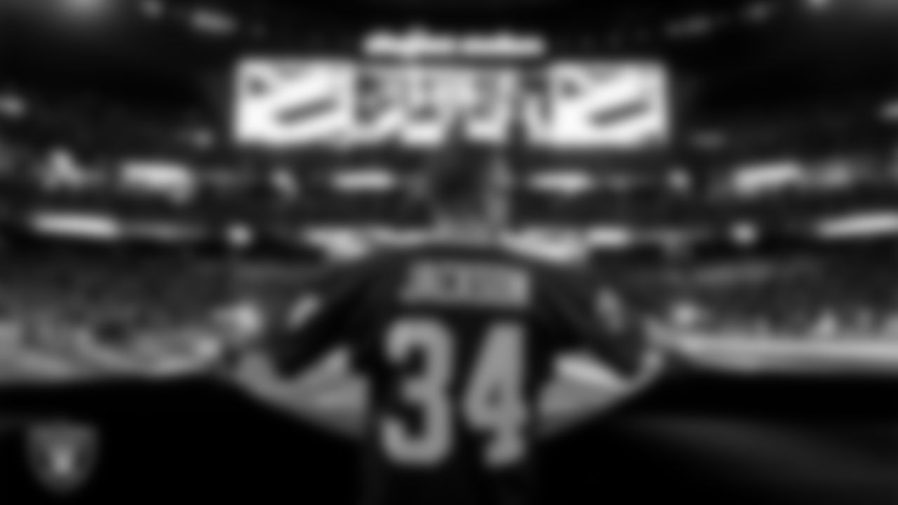 The American flag is displayed by Personal Seat License (PSL) holders on the field during the national anthem before the Las Vegas Raiders' regular season home game against the Dallas Cowboys at Allegiant Stadium.