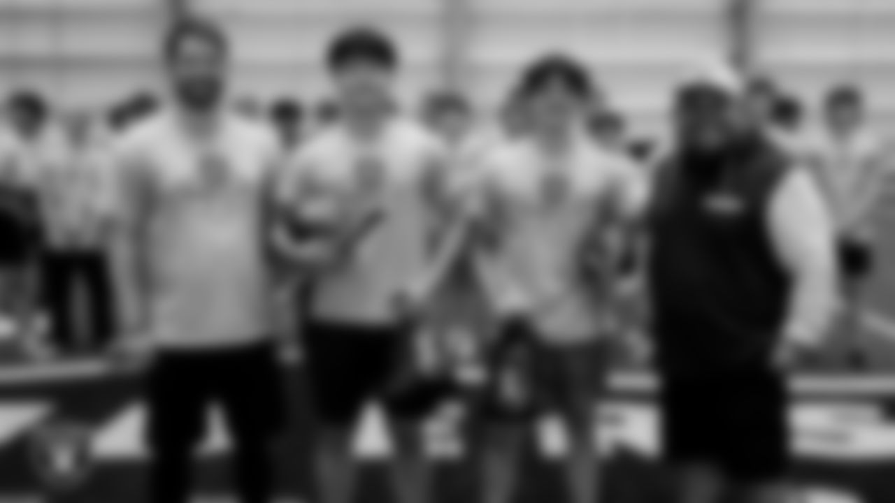 A coach and Las Vegas Raiders senior manager of football development Jordan Aguilar pose for a photo with top performing athletes after ELITE Academy at Intermountain Health Performance Center.