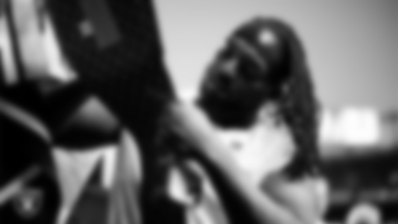 Las Vegas Raiders defensive tackle Adam Butler (69) signs autographs for fans before the regular season away game against the Denver Broncos at Empower Field at Mile High.