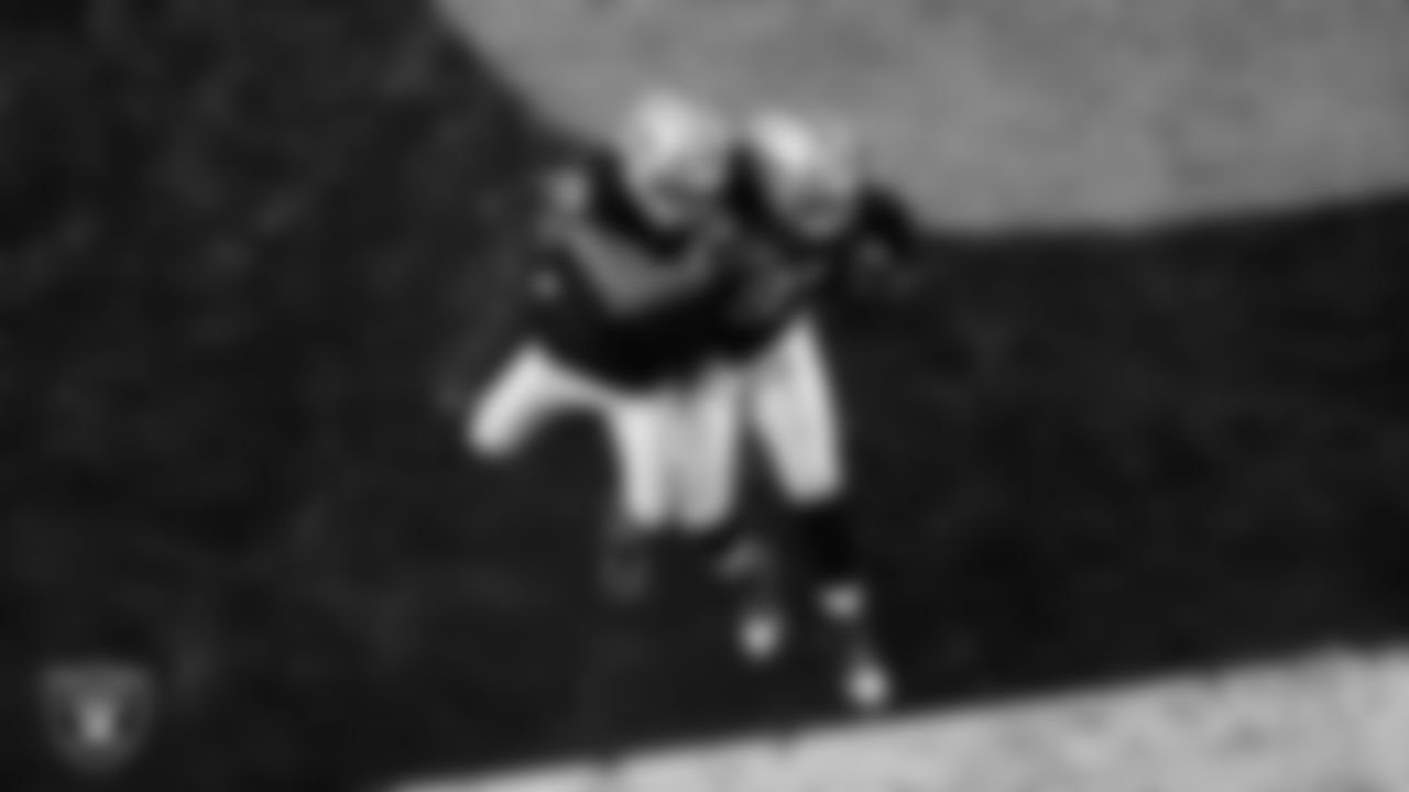 Las Vegas Raiders defensive tackle Tonka Hemingway (97) celebrates with defensive end Charles Snowden (49) after recovering a fumble during the regular season home game against the Dallas Cowboys at Allegiant Stadium.