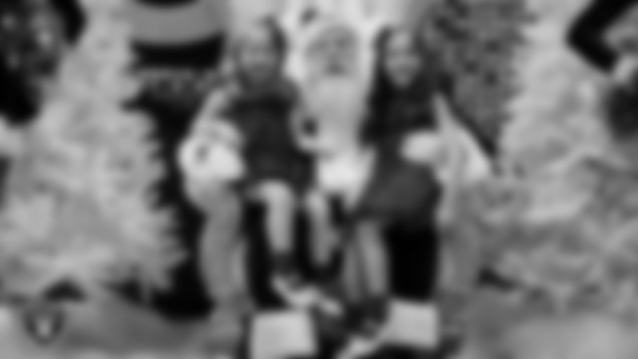 Junior Raiderettes pose for a photo with Santa during the Junior Raiderettes Banquet at The Studio.