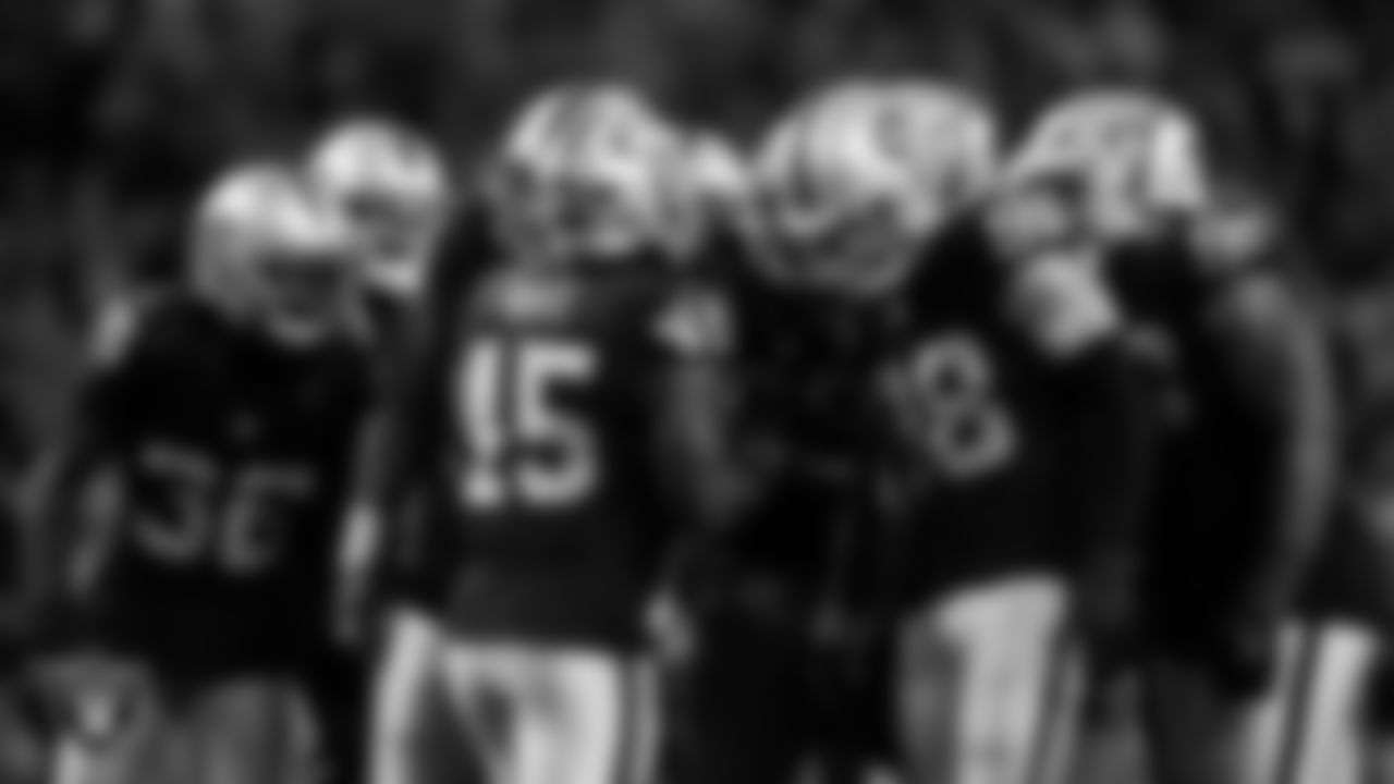 The Las Vegas Raiders defense huddles during the regular season home game against the Los Angeles Chargers at Allegiant Stadium.
