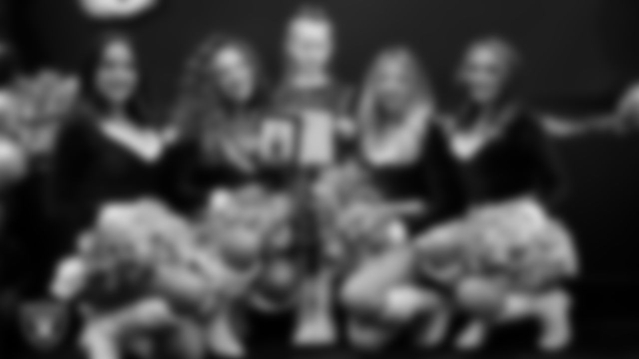 Raiderettes pose for a photo with a Junior Raiderette during the Junior Raiderettes Banquet at The Studio.